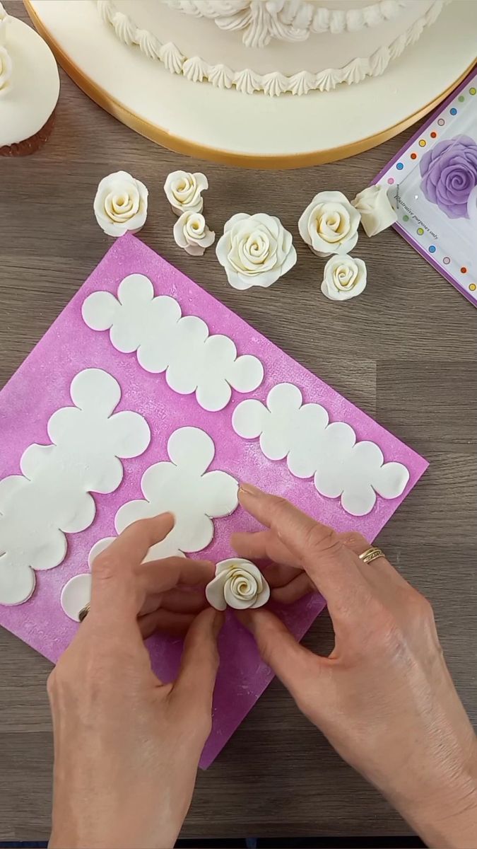 a person making paper flowers on top of a table