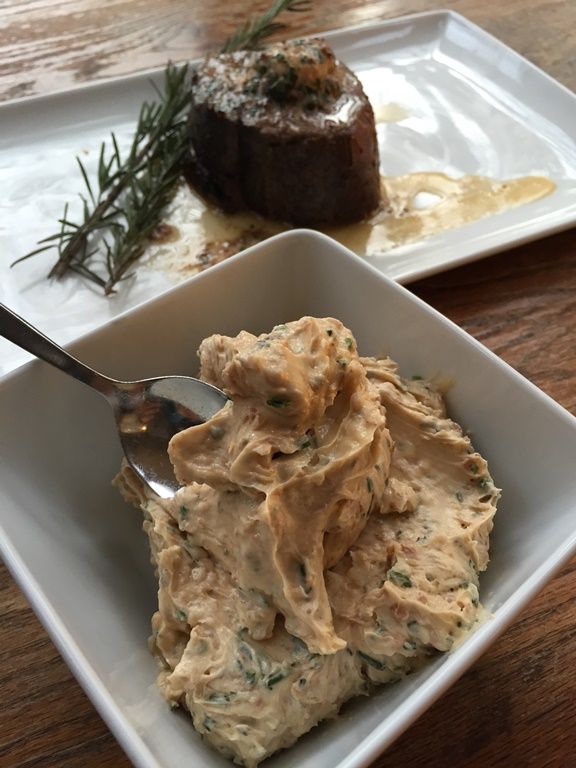 two plates with food on them, one has a spoon in it