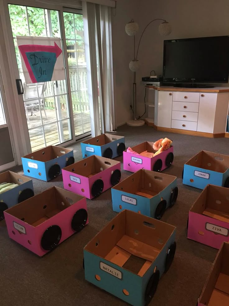 a room filled with lots of cardboard boxes on top of carpeted floor next to windows