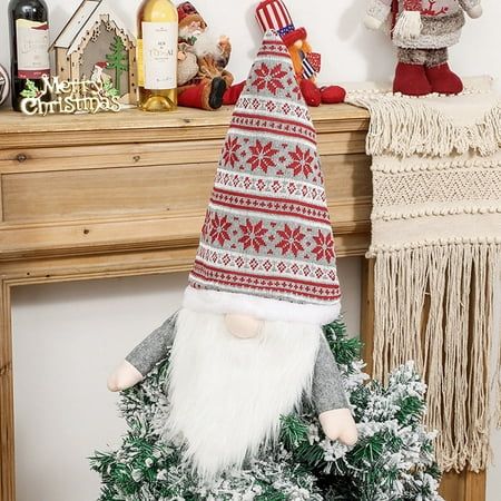 an image of a christmas decoration with gnomes on the mantle and other holiday decorations