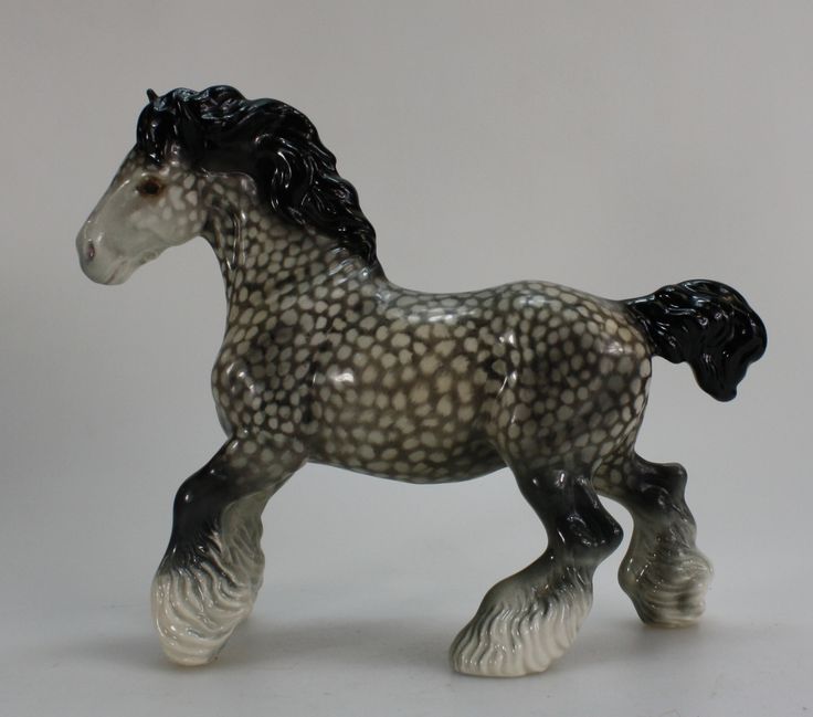 a black and white horse figurine sitting on top of a table