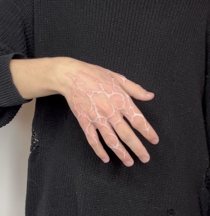 a woman's hand with white paint on it