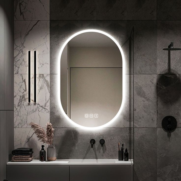 a bathroom with a round mirror above the sink