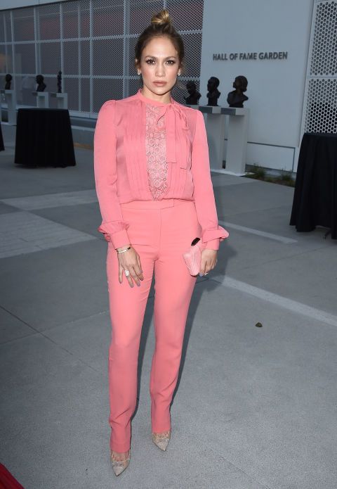 a woman in pink is posing for the camera