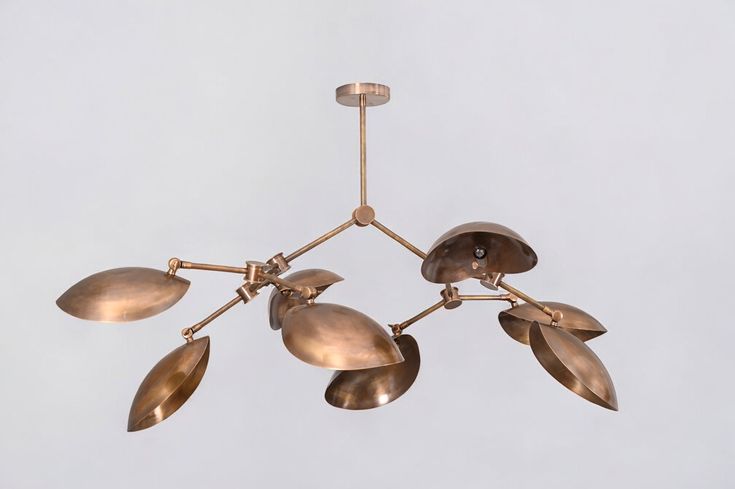 a chandelier with five lights hanging from it's sides and four leaves on each end