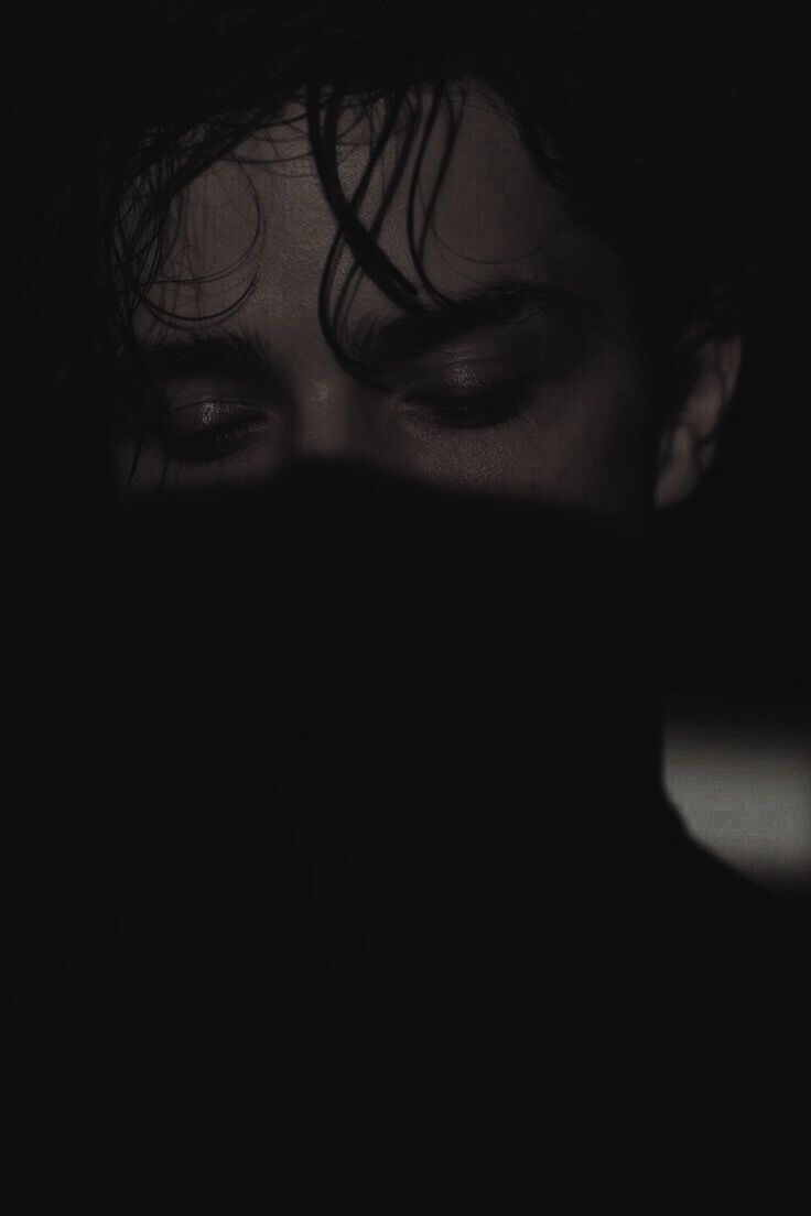 a close up of a person's face in the dark