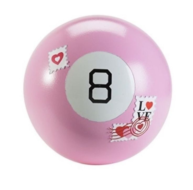 a pink pool ball with stickers on it and the number eight in black ink