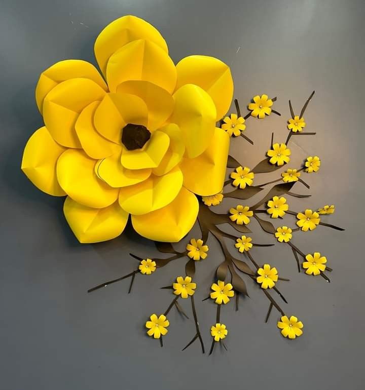 a bunch of yellow flowers sitting on top of a gray table next to each other