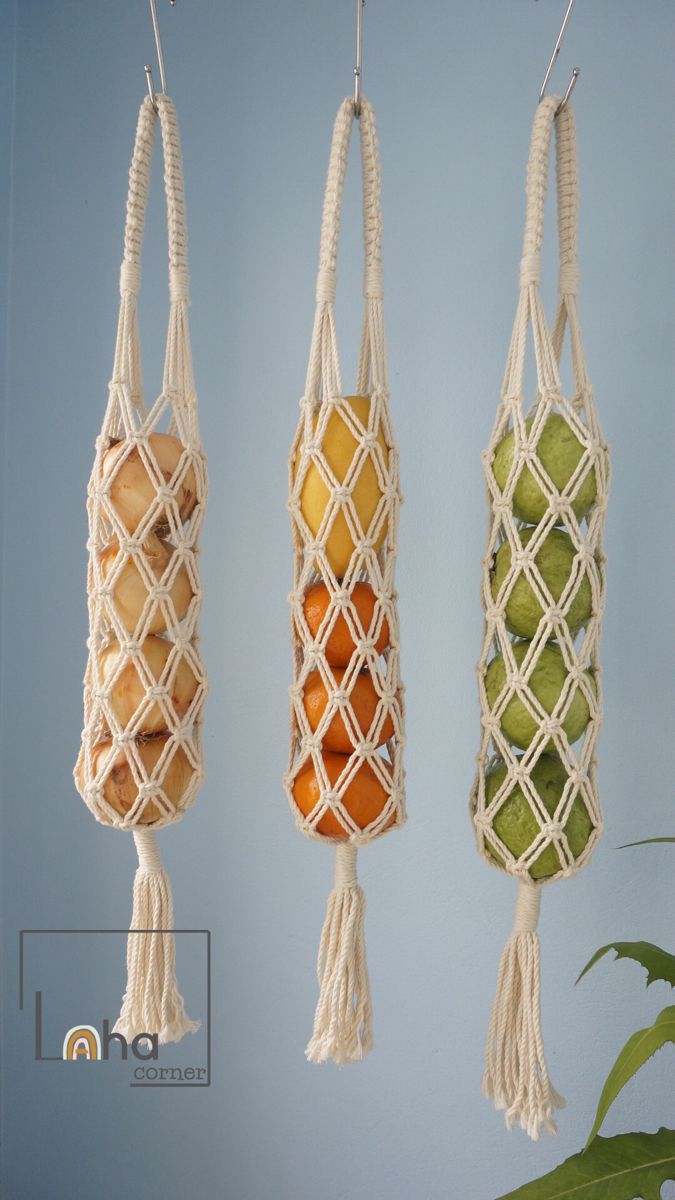 three macaroni and cheeses hanging from hooks on the wall, each with different fruits in them