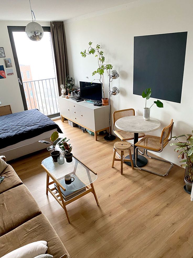 a living room filled with furniture and a flat screen tv sitting on top of a wooden floor