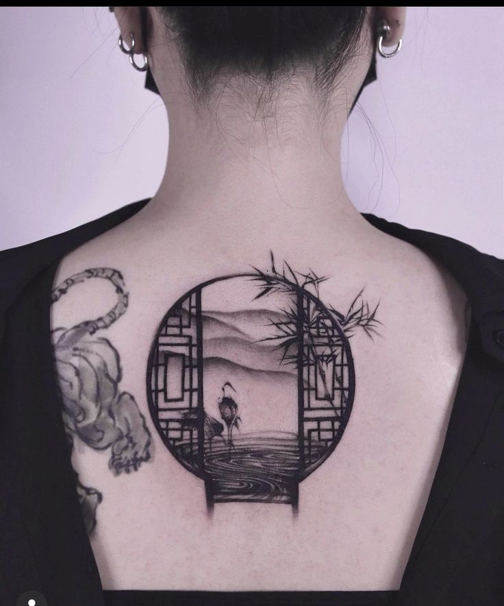 a woman with a tattoo on her back has an image of a person in the mirror