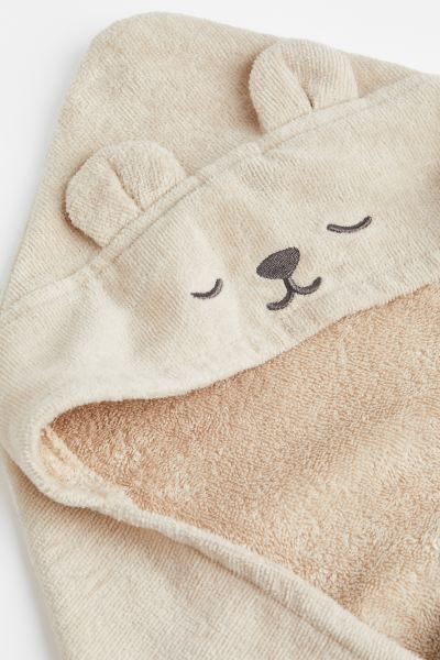 a close up of a towel with a bear face on it