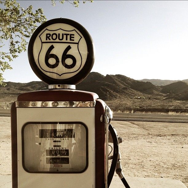 an old fashioned gas pump with a route 66 sign on top