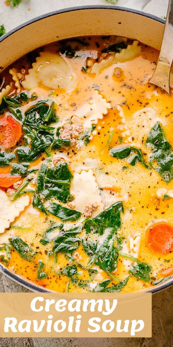 creamy ravioli soup with spinach and carrots in a large pot on the table