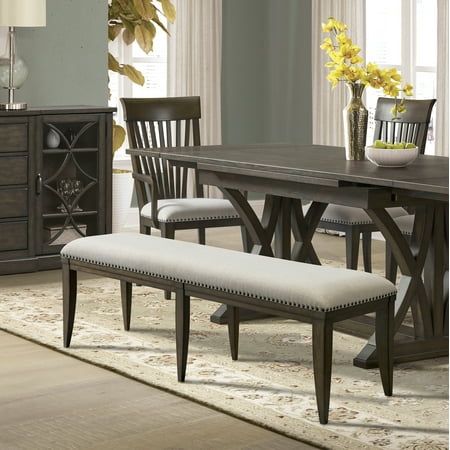 a dining room table with chairs and a bench in front of it on a rug