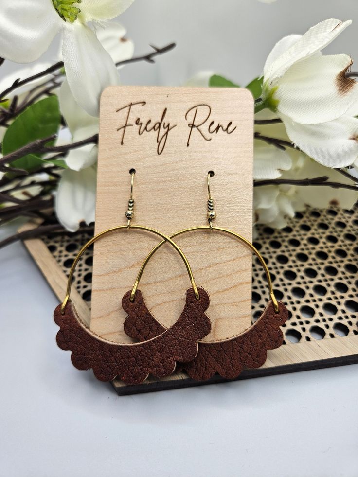 Beautiful, lightweight cork on genuine leather earrings.  Perfect for everyday wear. You will love these trendy, cork on leather earrings.  The brass arch adds a subtle charm to these beautiful earrings without adding extra weight. Each pair is handmade by us with lead free, stainless steel hooks. They hang at approximately 2.5 inches for the perfect everyday look. All earrings may vary slightly due to leather patterns. Colors may vary slightly due to screen variations. Minimalist Brown Hoop Earrings For Gift, Minimalist Brown Hoop Earrings For Everyday, Everyday Brown Hoop Earrings With Ear Wire, Brown Nickel-free Hoop Earrings For Everyday, Nickel-free Brown Hoop Earrings For Everyday, Trendy Brown Jewelry For Everyday Use, Everyday Brown Metal Earrings, Trendy Brown Hoop Earrings For Everyday, Brown Brass Hoop Earrings As Gift