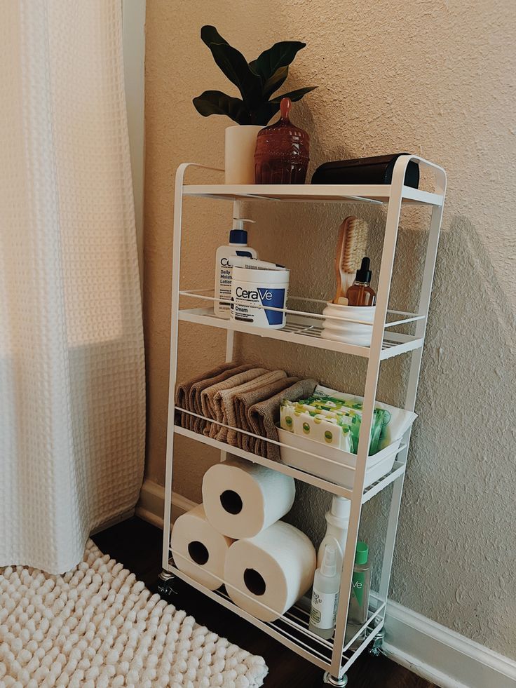 a bathroom shelf filled with toilet paper and other items