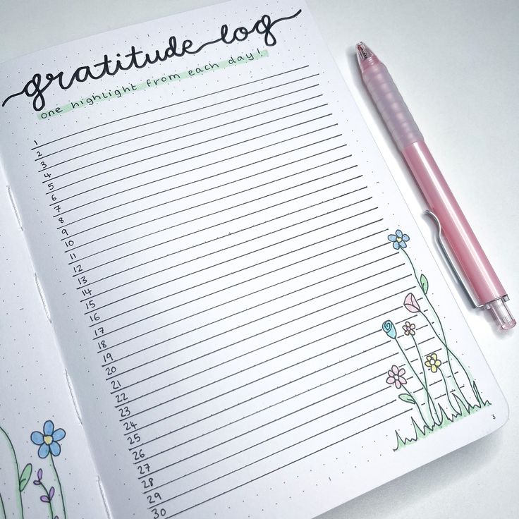 a notepad with writing on it next to a pen and flowered notebook paper