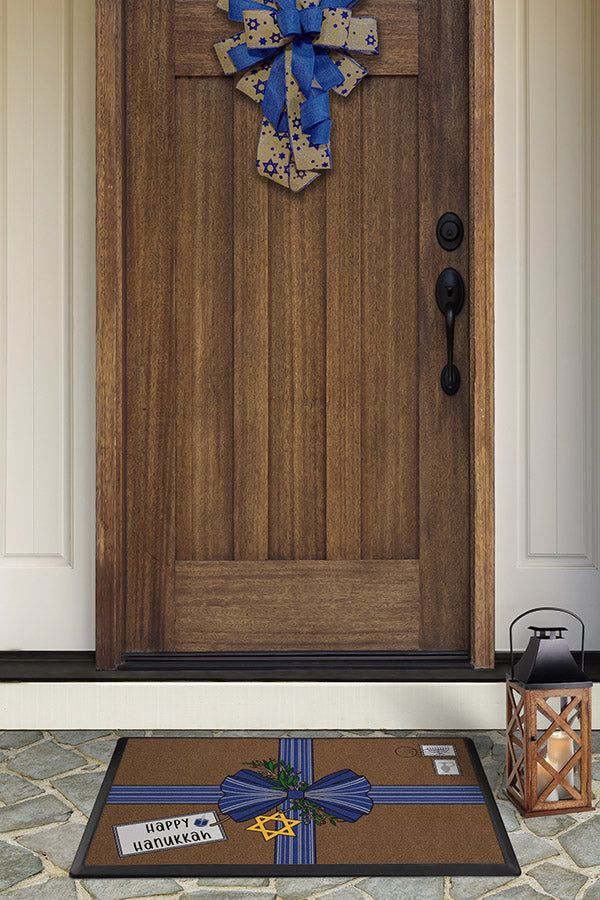 a wooden door with a cross on it and a welcome mat in front of it