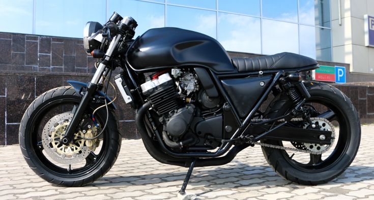 a black motorcycle parked in front of a building