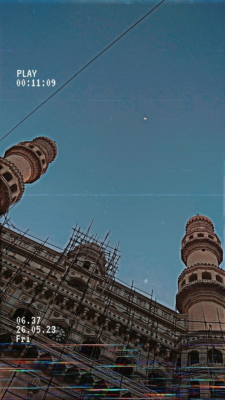 an old building with scaffolding around it and a clock tower in the ...