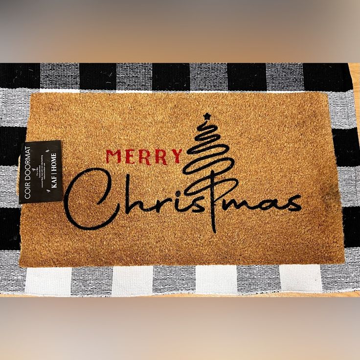 a merry christmas door mat with a tree on it