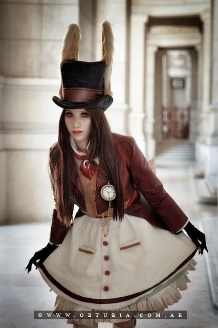 a woman in a dress and top hat is posing for a photo on instagram