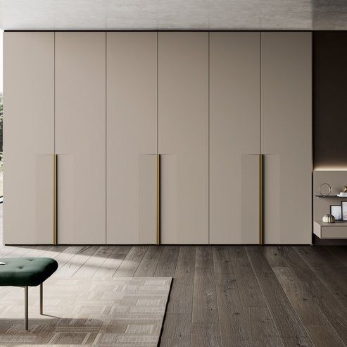 a living room filled with furniture next to a wall covered in white and brown cabinets