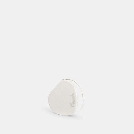 a small white object sitting on top of a table