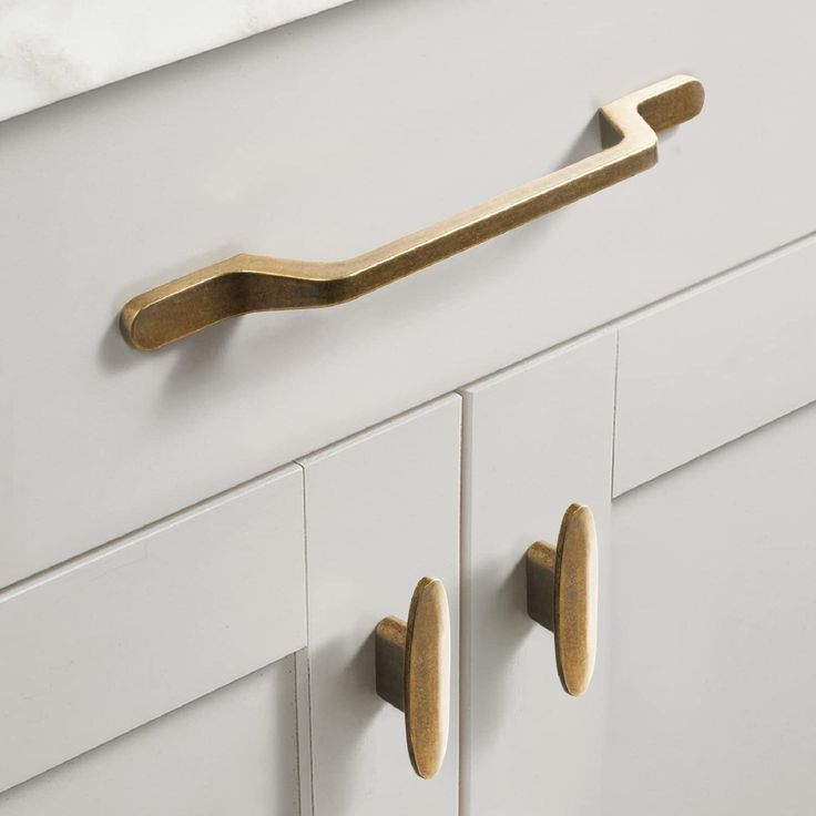 a close up of a drawer with some knobs and handles on the door handle