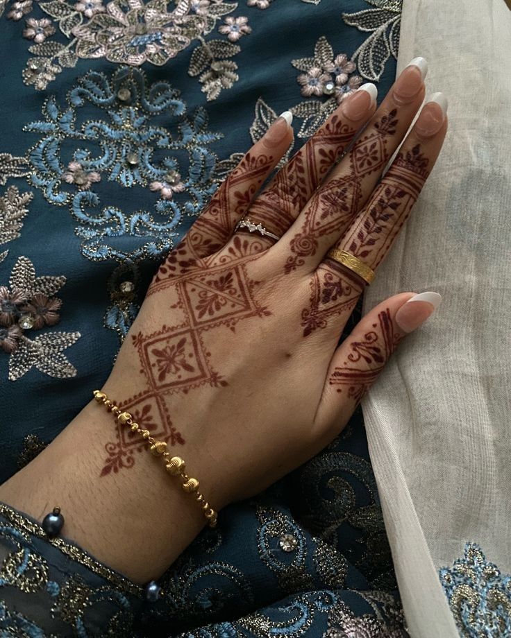 a woman's hand with henna on it