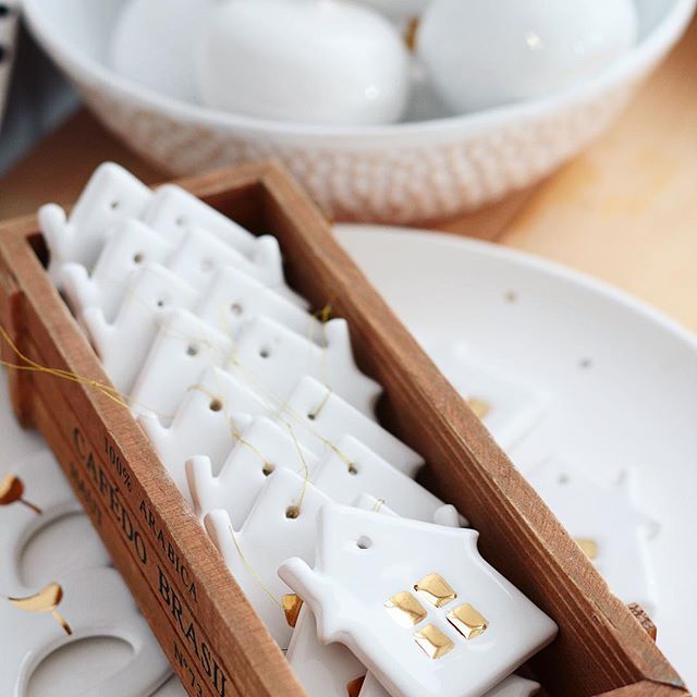 a wooden box filled with white ceramic ornaments