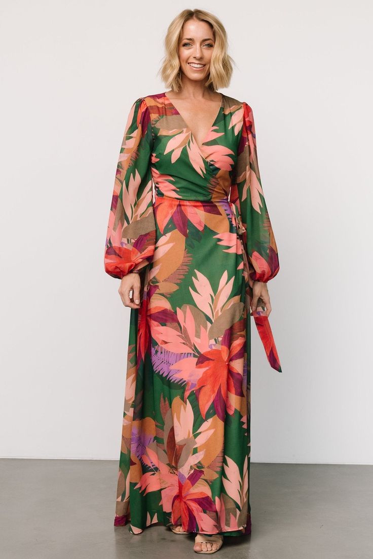 True wrap style for your every vacay need Green with multicolor tropical floral print Chiffon material that flows beautifully True wrap style with waist tie Flattering surplice neckline Long sleeves with elastic cuffs Maxi skirt length Fully lined, excluding sleeves Self and Lining: 100% Polyester Trina is 5'6, cup size 32D, size 2 and is wearing size S Floral Print Wrap Dress For Beach, Floral Print Wrap Dress For Vacation, Floral Wrap Dress For Beach, Green Tie Waist Wrap Dress For Vacation, Floral Print Maxi Wrap Dress For Vacation, Printed V-neck Wrap Dress For Vacation, Summer Floral Print Wrap Dress For Vacation, Multicolor Floral Print Wrap Dress For Beach, Tropical Formal Wedding Attire