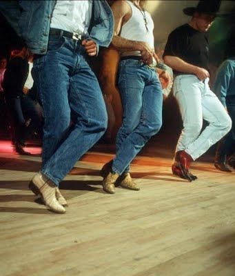 three people are dancing on the dance floor