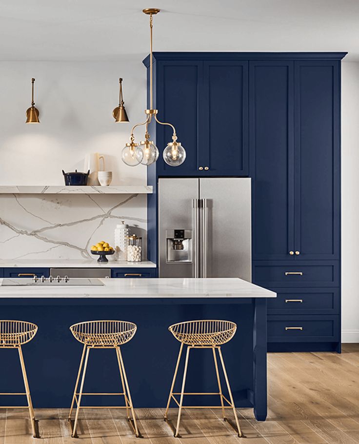 an image of a kitchen setting with blue cabinets and stools on the countertop