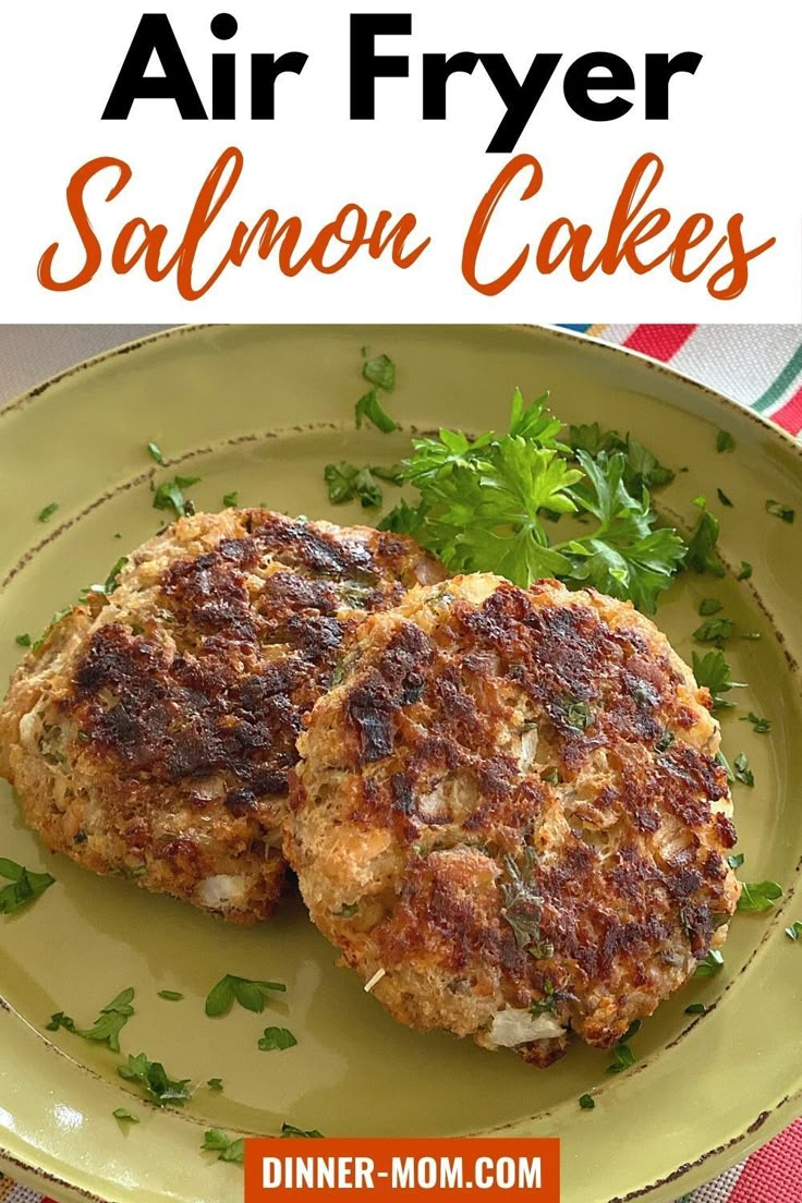 two salmon cakes on a green plate with parsley garnish and text overlay that reads air fryer salmon cakes