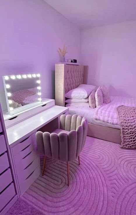 a bedroom with purple walls and carpeted flooring is pictured in this image, there are