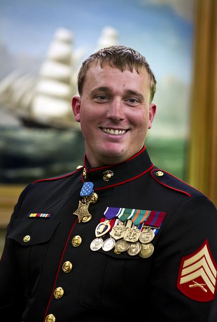 a man in uniform is smiling for the camera