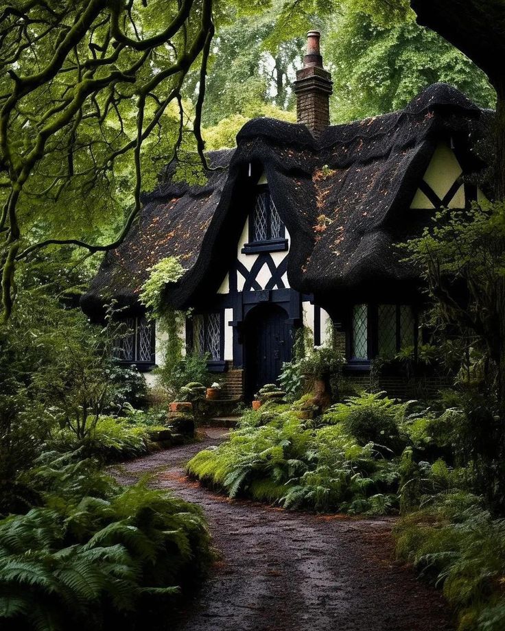 a house with a thatched roof surrounded by trees and ferns in the woods,