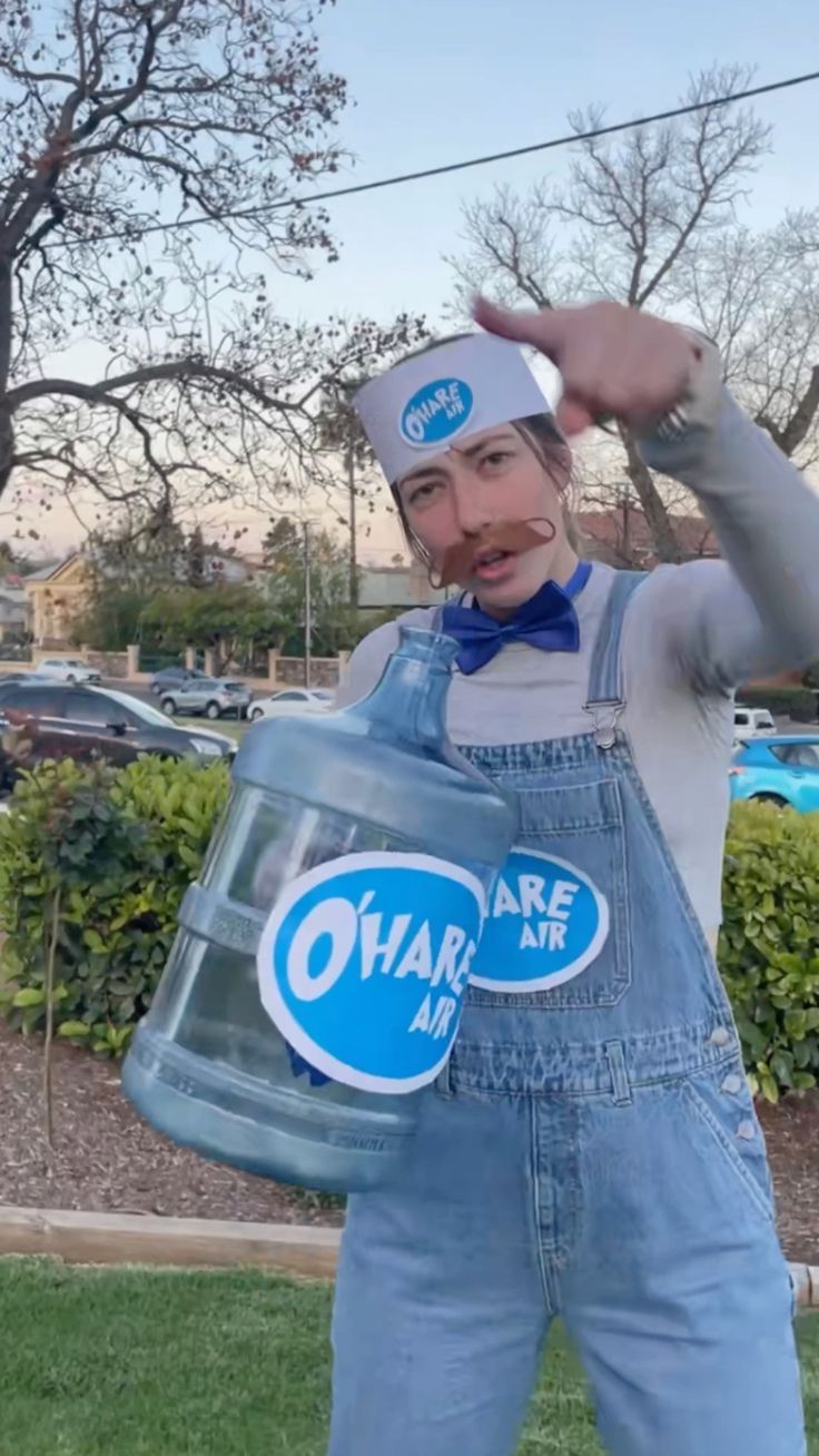 a man in overalls and a hat holding a water bottle with the words share air on it