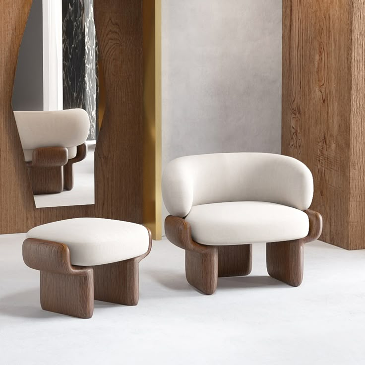 a white chair and ottoman sitting next to each other in front of a mirror on the wall