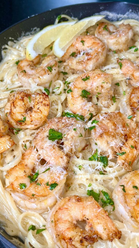 pasta with shrimp and parmesan cheese in a skillet