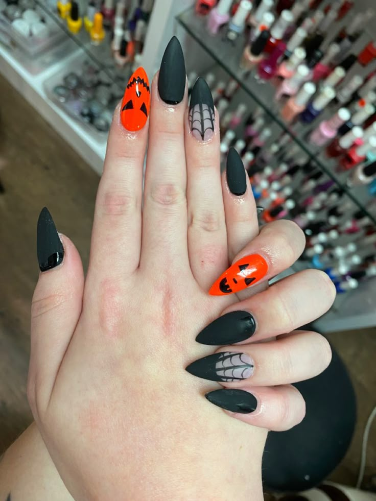 Black And Orange Pumpkin Nails, Matte Black And Orange Nails, October Nails Halloween Acrylic, Fall Pointy Nails, Orange And Black Nails Halloween, Pumpkin Face Nails, Matte Black Halloween Nails, Jackolantern Nails, Matte Halloween Nails