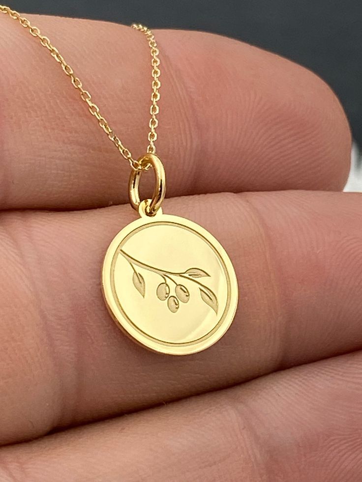 "Dainty 14k Solid Gold Olive Tree Branch Leaf Necklace, Personalized Olive Tree Pendant, Greek Leaf Necklace, Branch Leaf Pendant 14k Solid Gold Choose What Size You Want the Pendant Using The First Option Box Choose If you Want Thinner, Thicker  Or Without Chain Using The Second Option Box Photos Are For The 0.5 inch Diameter Pendant Pendant thickness : 0.5mm  Contact us if you want it thicker Inner diameter of jump ring : 4mm Contact us if you need it bigger              No1 chain width : 0.87mm                 No2 chain width : 1.30mm     ♥ Material of pendant and chain: Solid Gold k14 ♥ Packaging: All of our jewelry are beautifully boxed and ready for gifting For more personalized designs take a look here: ♥ www.etsy.com/listing/736955132 ♥ www.etsy.com/listing/819494857 ♥ www.etsy.com Olive Tree Branch, Preppy Jewelry, Second Option, Classy Jewelry, Tree Pendant, Fancy Pants, Olive Tree, Leaf Necklace, Necklace Personalized