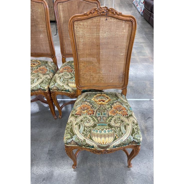 four chairs with upholstered back and seat cushions, all in different patterns on them