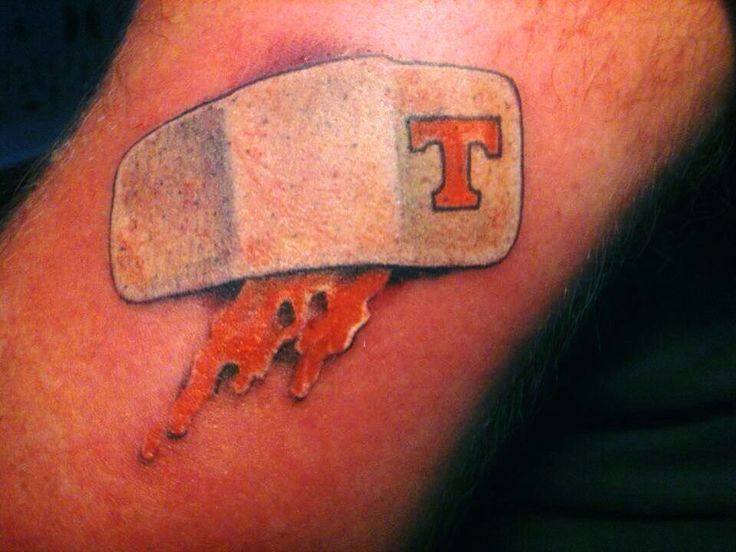 a tattoo with the letter t on it