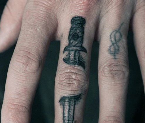 a person's hand with a tattoo on it