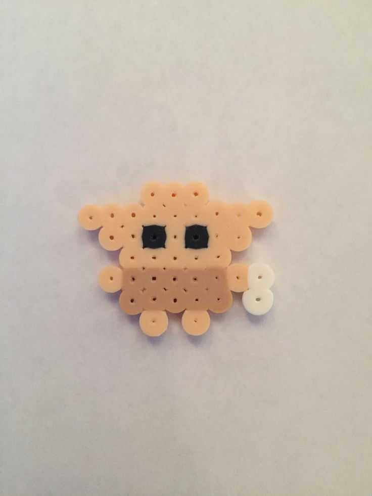 a close up of a small animal made out of plastic beads on a white surface