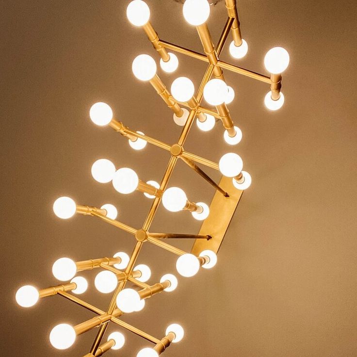 a chandelier with many lights hanging from it's sides in a room