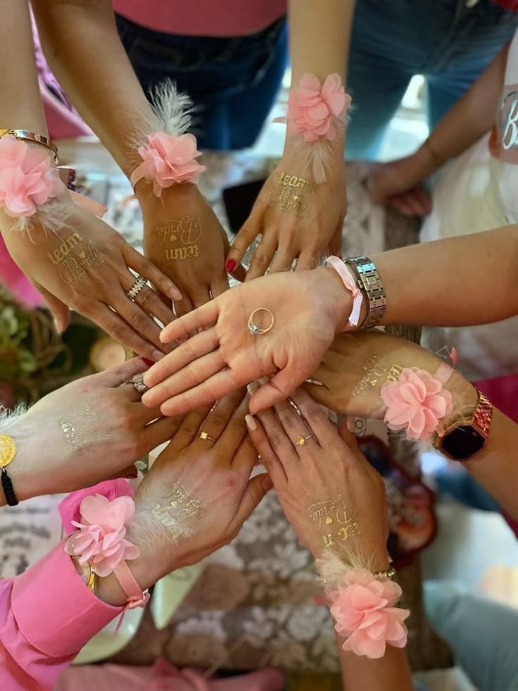 a group of people holding their hands together